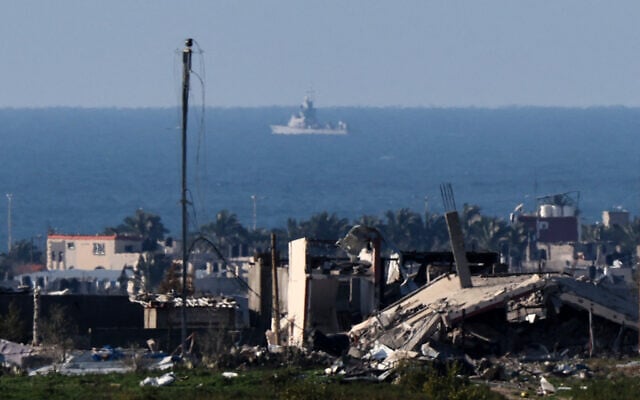 A picture taken from southern Israel on the border with the Gaza Strip shows a naval ship near the coast of the Palestinian territory on January 25, 2024. (Jack Guez/AFP) A picture taken from southern Israel on the border with the Gaza Strip shows a naval ship near the coast of the Palestinian territory on January 25, 2024. (Jack Guez/AFP)