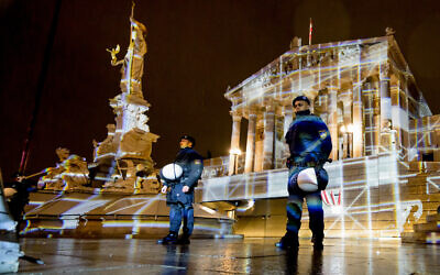 Illustrative - Police stand by during a rally under the motto "Defend Democracy" against right-wing extremism, racism and anti-Semitism as rain falls in front of the parliament in Vienna, Austria on January 26, 2024.(Photo by Joe Klamar / AFP)