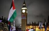 A Palestinian flag flaps in the air by a message reading 'Stop bombs' projected on Big Ben (the Elizabeth Tower), at the Palace of Westminster, in London on February 21, 2024. (Henry Nicholls/AFP)