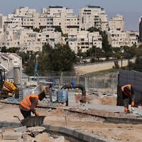 Palestinian laborers work at a construction site in Ma'ale Adumim, in the West Bank, on February 29, 2024. (Menahem Kahana / AFP)