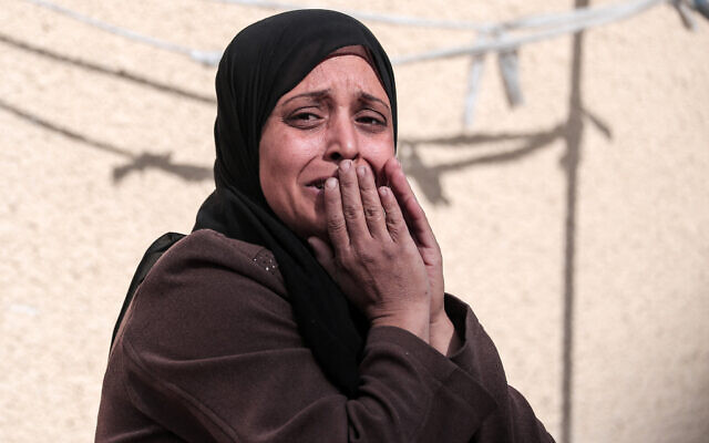 A Palestinian woman mourns a relative killed during overnight Israeli strikes on Deir al-Balah in the central Gaza Strip, at the morgue of the Shuhada al-Aqsa on March 1, 2024 (AFP)