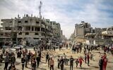 Palestinians gather in a street as humanitarian aid is airdropped in Gaza City on March 1, 2024, amid the ongoing conflict between Israel and the Hamas terror group. (AFP)