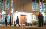 Police officers stand guard at the Synagoge Agudas Achim in Zurich, Switzerland on March 3, 2024. (Arnd WIEGMANN / AFP)