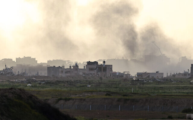 This picture taken from a position in southern Israel near the border with the Gaza Strip shows smoke billowing over the territory on March 3, 2024. (Menahem KAHANA / AFP)