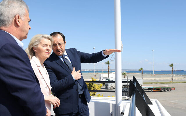 A handout picture provided by the Cypriot government's Press and Information Office (PIO) shows Cyprus' President Nikos Christodoulides (R) and President of the European Commission Ursula von der Leyen inspecting the Larnaca Port, in Larnaca, Cyprus on March 8, 2024 (Photo by Andreas LOUCAIDES / PIO / AFP)