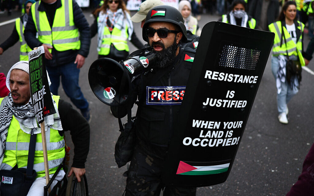 Illustrative: An anti-Israel activist shouts through a loudspeaker on a march through London, during a National Day of Action for Palestine on March 9, 2024. (HENRY NICHOLLS / AFP)