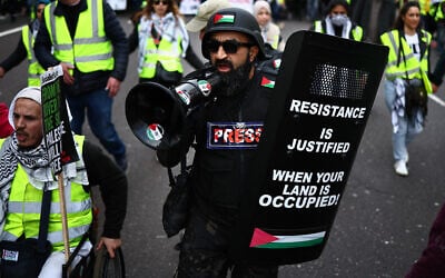 Illustrative: An anti-Israel activist shouts through a loudspeaker on a march through London, during a National Day of Action for Palestine on March 9, 2024. (HENRY NICHOLLS / AFP)
