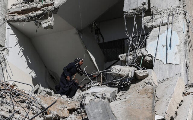 A Palestinian woman searches amid the rubble of a residential building hit in an overnight Israeli air strike in Rafah in the southern Gaza Strip on March 9, 2024. (Said Khatib/AFP) A Palestinian woman searches amid the rubble of a residential building hit in an overnight Israeli air strike in Rafah in the southern Gaza Strip on March 9, 2024. (Said Khatib/AFP)