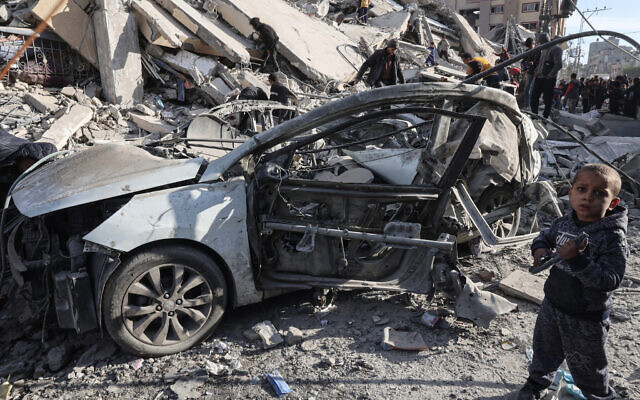 A young Palestinian boy stands next to a wrecked car in the rubble of a residential building hit in an overnight Israeli air strike in Rafah in the southern Gaza Strip on March 9, 2024. (Said Khatib/AFP) A young Palestinian boy stands next to a wrecked car in the rubble of a residential building hit in an overnight Israeli air strike in Rafah in the southern Gaza Strip on March 9, 2024. (Said Khatib/AFP)