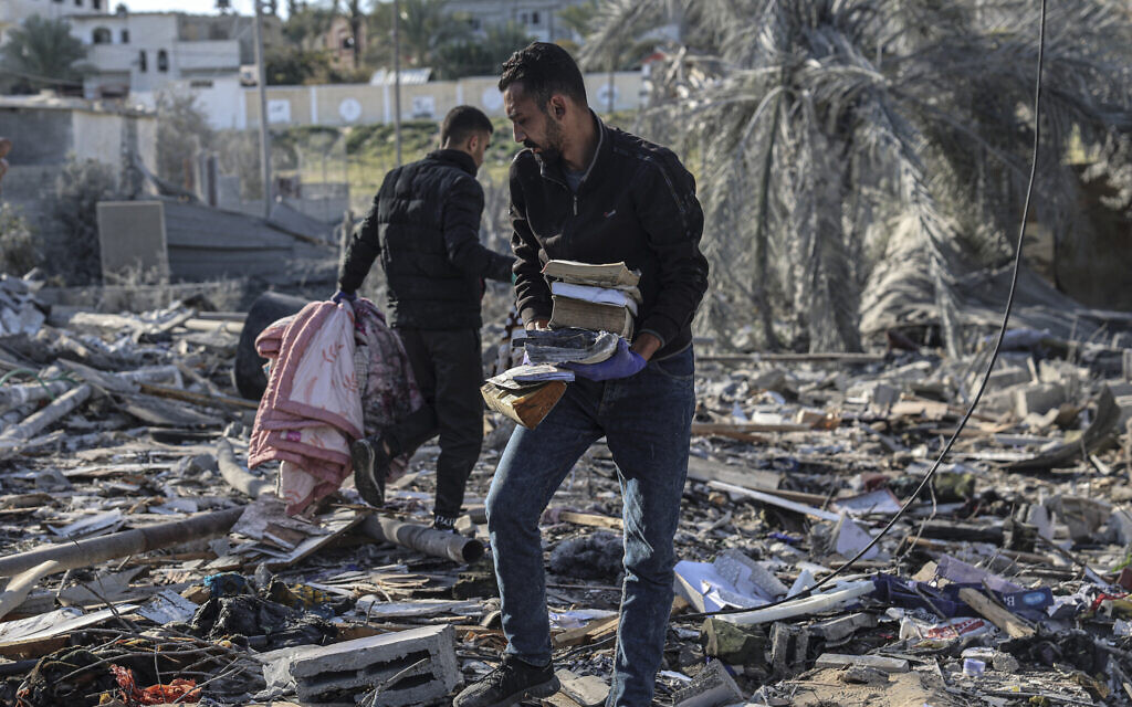 Palestinians search for their belongings amid the rubble of houses destroyed by Israeli bombardment in Rafah in the southern Gaza Strip on March 11, 2024. (SAID KHATIB / AFP)