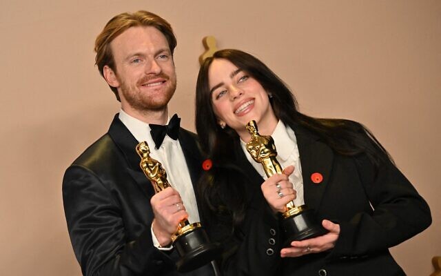 US singer-songwriter Billie Eilish and US singer-songwriter Finneas O'Connell, both wearing Gaza ceasefire pins, pose in the press room with the Oscar for Best Original Song for 'What Was I Made For' during the 96th Annual Academy Awards at the Dolby Theatre in Hollywood, California on March 10, 2024. (Robyn BECK / AFP)