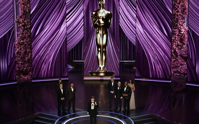 Irish actor Cillian Murphy accepts the award for Best Actor in a Leading Role for 'Oppenheimer,' flanked by (from back L) US actor Nicolas Cage, US actor Matthew McConaughey, Canadian-US actor Brendan Fraser, British actor Ben Kingsley and US actor Forest Whitaker, onstage during the 96th Annual Academy Awards at the Dolby Theatre in Hollywood, California on March 10, 2024. (Patrick T. Fallon / AFP)