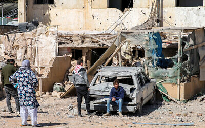 A youth sits by a damaged vehicle outside a destroyed building in the aftermath of an overnight Israeli airstrike on the city of Baalbek in east central Lebanon on March 12, 2024 (Photo by AFP) A youth sits by a damaged vehicle outside a destroyed building in the aftermath of an overnight Israeli airstrike on the city of Baalbek in east central Lebanon on March 12, 2024 (Photo by AFP)