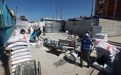 UN workers are pictured at a UNRWA warehouse/distribution center in Rafah, in the southern Gaza Strip, which was partially hit by an strike on March 13, 2024, amid the war between Israel and the Palestinian terror group Hamas.(Mohammed Abed/AFP)