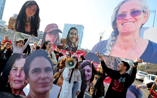 Activists and families of hostages held by terror groups in Gaza since October 7 block the Ayalon Highway in Tel Aviv with large cutouts of their portraits, during a protest calling for their release, March 14, 2024. (Jack Guez/AFP) Activists and families of hostages held by terror groups in Gaza since October 7 block the Ayalon Highway in Tel Aviv with large cutouts of their portraits, during a protest calling for their release, March 14, 2024. (Jack Guez/AFP)