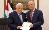 Palestinian Authority President Mahmoud Abbas, left, poses with the newly appointed Palestinian Authority Prime Minister Mohammad Mustafa, in the West Bank city of Ramallah, March 14, 2024. (Palestinian Authority Press Office/AFP)