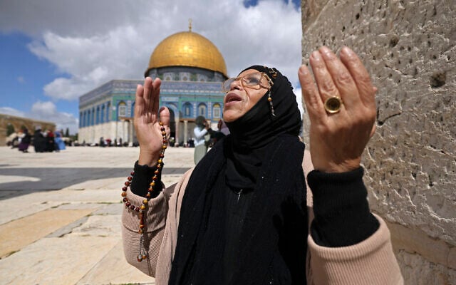A Muslim devotee offers first Friday noon prayers of Ramadan in front of the Dome of the Rock on the Temple Mount compound in the Old City of Jerusalem on March 15, 2024. (Photo by AHMAD GHARABLI / AFP)