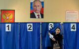 A woman votes in Russia's presidential election at a polling station in Donetsk, Russian-controlled Ukraine, amid the Russia-Ukraine war on March 16, 2024 (Credit: Stringer/ AFP).