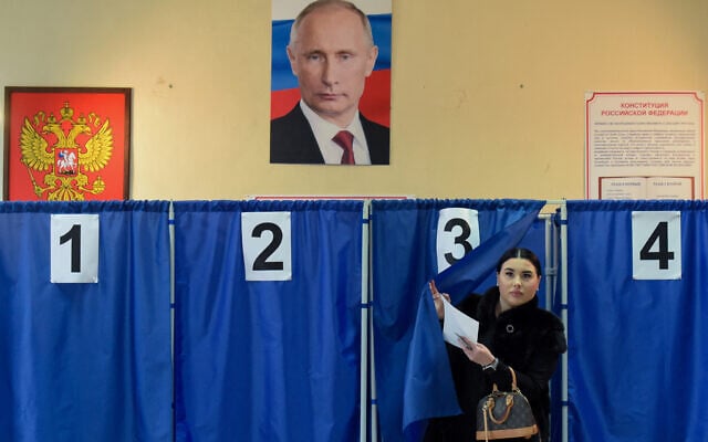 A woman votes in Russia's presidential election at a polling station in Donetsk, Russian-controlled Ukraine, amid the Russia-Ukraine war on March 16, 2024 (Credit: Stringer/ AFP). A woman votes in Russia's presidential election at a polling station in Donetsk, Russian-controlled Ukraine, amid the Russia-Ukraine war on March 16, 2024 (Credit: Stringer/ AFP).