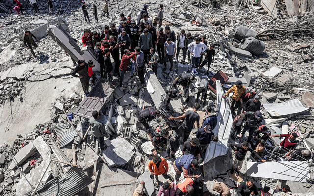 People and first responders inspect the rubble and debris of a building that collapsed following an Israeli air strike in Rafah in the southern Gaza Strip on March 20, 2024 (SAID KHATIB / AFP) People and first responders inspect the rubble and debris of a building that collapsed following an Israeli air strike in Rafah in the southern Gaza Strip on March 20, 2024 (SAID KHATIB / AFP)