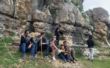 Palestinian rock climbers take a break as they practice their hobby at a site in Wadi al-Ghul about 20 kilometers by road south of Bethlehem in the West Bank on March 16, 2024. (Sonia Logre/ AFP).
