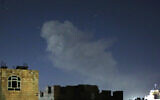 A plume of smoke rises after a reported airstrike in the Yemeni capital Sanaa on March 22, 2024. (Mohammed Huwais/AFP)