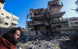 A man inspects the damage to a building after overnight Israeli bombardment in Rafah in the southern Gaza Strip on March 25, 2024. (MOHAMMED ABED / AFP)