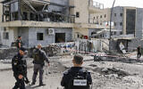 Israeli forces check a building that was hit by a Hezbollah rocket in Kiryat Shmona in northern Israel near the Lebanon border, on March 27, 2024. (Jalaa MAREY / AFP)