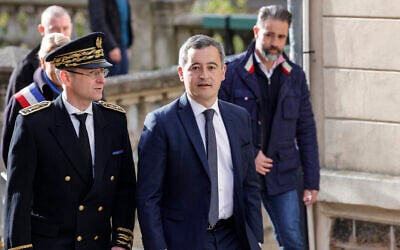 French Interior Minister Gerald Darmanin (2nd R) and Police Prefect of the French Val d'Oise department, Philippe Court (L) arrive at the Saint-Maclou Cathedral in Pontoise, north of Paris, on March 31, 2024. (GEOFFROY VAN DER HASSELT / AFP)