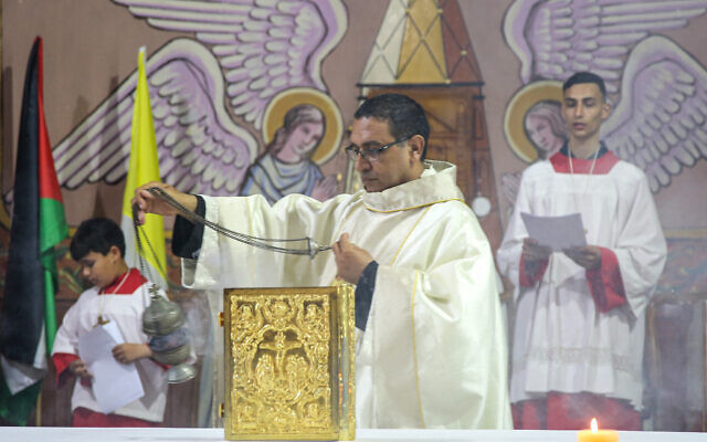 A priest leads the Easter Sunday Mass at the Palestinian Catholic Holy Family Church in Gaza City, on March 31, 2024. (AFP)