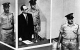 Adolf Eichmann standing in his glass cage, flanked by guards, in the Jerusalem courtroom during his trial in 1961 for war crimes committed during World War II. (AP Photo/File)