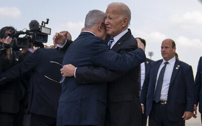 US President Joe Biden, right, hugs Prime Minister Benjamin Netanyahu after arriving at Ben Gurion International Airport near Tel Aviv, October 18, 2023. (AP Photo/Evan Vucci)