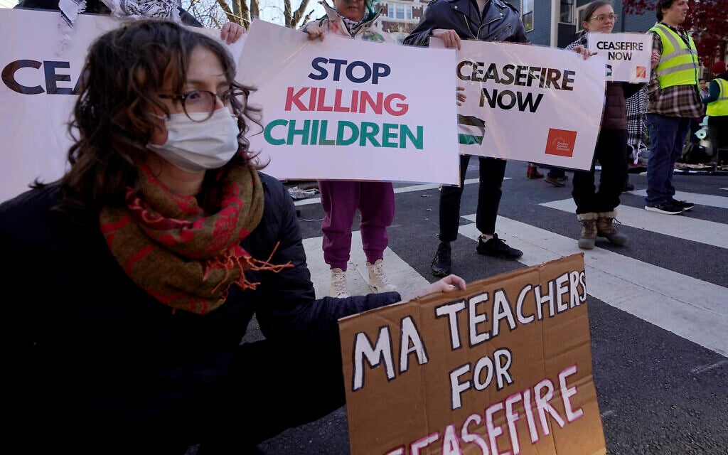 Illustrative: Anti-Israel demonstrators display signs outside the home of US Sen. Elizabeth Warren during a protest on November 19, 2023, in Cambridge, Massachusetts. (AP Photo/Steven Senne) Illustrative: Anti-Israel demonstrators display signs outside the home of US Sen. Elizabeth Warren during a protest on November 19, 2023, in Cambridge, Massachusetts. (AP Photo/Steven Senne)