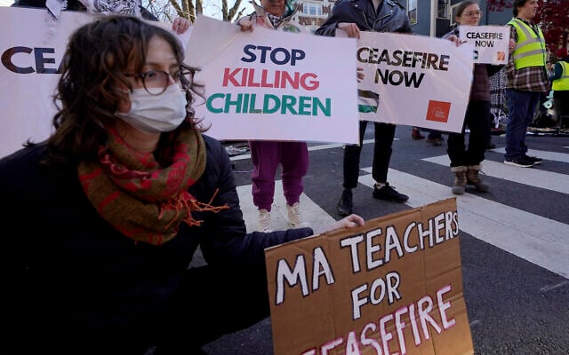 Illustrative: Anti-Israel demonstrators display signs outside the home of US Sen. Elizabeth Warren during a protest on November 19, 2023, in Cambridge, Massachusetts. (AP Photo/Steven Senne)