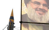 Illustrative: An Iranian domestically built missile is displayed in front of the portrait of the Lebanese Hezbollah leader Hassan Nasrallah during a rally of Iran's Basij paramilitary force in support of the Palestinians in Tehran, Iran, November 24, 2023. (AP Photo/Vahid Salemi)
