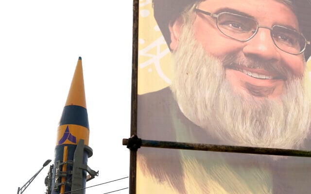 Illustrative: An Iranian domestically built missile is displayed in front of the portrait of the Lebanese Hezbollah leader Hassan Nasrallah during a rally of Iran's Basij paramilitary force in support of the Palestinians in Tehran, Iran, November 24, 2023. (AP Photo/Vahid Salemi) Illustrative: An Iranian domestically built missile is displayed in front of the portrait of the Lebanese Hezbollah leader Hassan Nasrallah during a rally of Iran's Basij paramilitary force in support of the Palestinians in Tehran, Iran, November 24, 2023. (AP Photo/Vahid Salemi)