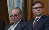 US Senate Majority Leader Chuck Schumer (right) and House Speaker Mike Johnson listen to remarks during a Hanukkah gathering at the Capitol in Washington, December 12, 2023. (AP Photo/J. Scott Applewhite)