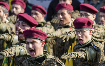Hezbollah fighters chant slogans as they attend the funeral procession of senior Hezbollah commander Wissam Tawil, during his funeral procession in the village of Khirbet Selm, south Lebanon, Jan. 9, 2024 (AP Photo/Hussein Malla)