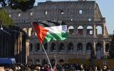 Illustrative: A Palestinian flag is waved in front of the Colosseum, during a rally in support of the Palestinians in Rome, January 13, 2024. (AP Photo/Gregorio Borgia)