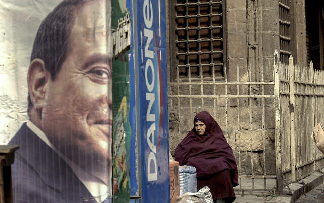 An Egyptian vendor sits behind a half of a poster with a portrait of Egyptian President Abdel-Fattah el-Sissi, at a market in Cairo, Egypt, Friday, Jan. 26, 2024. (AP Photo/Amr Nabil) An Egyptian vendor sits behind a half of a poster with a portrait of Egyptian President Abdel-Fattah el-Sissi, at a market in Cairo, Egypt, Friday, Jan. 26, 2024. (AP Photo/Amr Nabil)