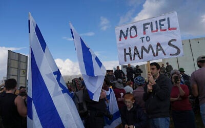 Israeli police prevent activists from blocking trucks carrying humanitarian aid into the Gaza Strip at the Kerem Shalom border crossing between Israel and Gaza, in southern Israel, January 29, 2024. (AP Photo/Tsafrir Abayov)