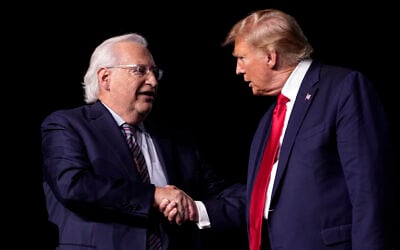 Then-Republican presidential candidate, US President Donald Trump, right, greets David Friedman, who served as his ambassador to Israel, at the National Religious Broadcasters convention at the Gaylord Opryland Resort and Convention Center on February 22, 2024, in Nashville, Tennessee. (AP Photo/George Walker IV)