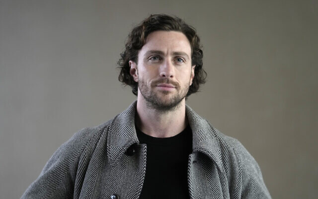 Actor Aaron Taylor-Johnson attends the Giorgio Armani women's Fall-Winter 2024-25 collection presented in Milan, Italy, Feb. 25, 2024. (AP Photo/Luca Bruno)