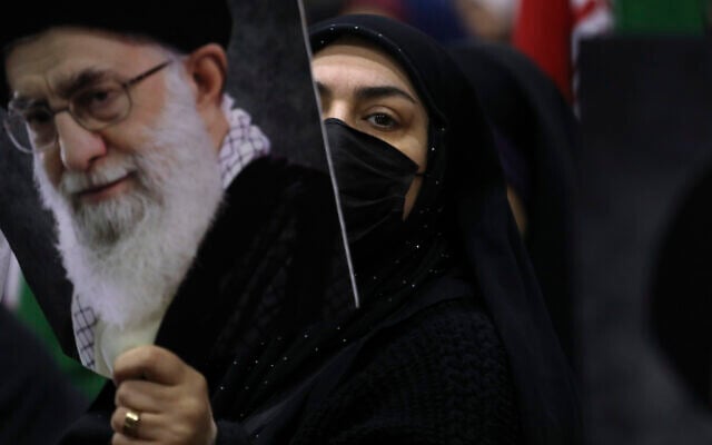 An Iranian woman holds a poster of the Supreme Leader Ayatollah Ali Khamenei during an election campaign rally ahead of the March 1, parliamentary and Assembly of Experts elections, in Tehran, Iran, Tuesday, Feb. 27, 2024. (AP Photo/Vahid Salemi)