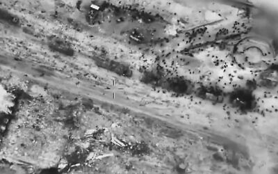 In this screen grab taken from video and released by the Israeli army on Thursday, Feb. 29, 2024, Palestinians surround aid trucks in northern Gaza. (IDF via AP)