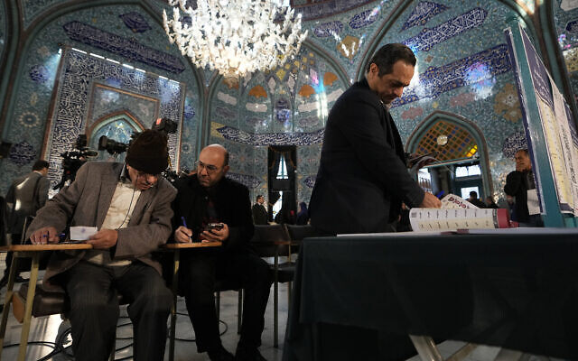 Voters fill out their ballots in the parliamentary and assembly of experts elections at a polling station in Tehran, Iran, Friday, March 1, 2024. (AP Photo/Vahid Salemi) Voters fill out their ballots in the parliamentary and assembly of experts elections at a polling station in Tehran, Iran, Friday, March 1, 2024. (AP Photo/Vahid Salemi)