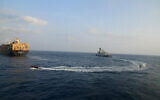 This photograph shared by Indian navy on the X platform shows a firefighting team from Indian Navy vessel INS Kolkata responding to a fire on Liberian-flagged Merchant ship MSC Sky II caused due to a suspected drone/missile attack in the Gulf of Aden, March 5, 2024. (Indian Navy on X via AP)