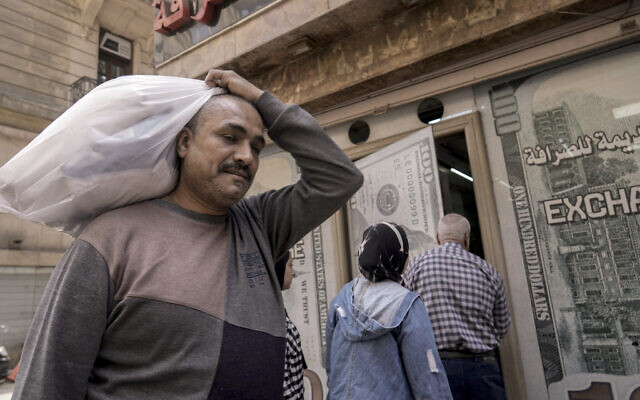 An Egyptian man walks past an exchange office in Cairo, Egypt, Wednesday, March 6, 2024. (AP Photo/Amr Nabil) An Egyptian man walks past an exchange office in Cairo, Egypt, Wednesday, March 6, 2024. (AP Photo/Amr Nabil)