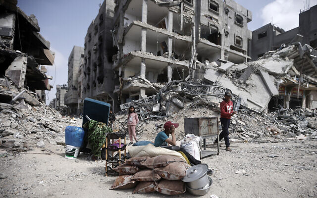 Palestinians sit by their belongings after visiting buildings destroyed in Khan Younis, Gaza Strip, March 6, 2024. (Mohammed Dahman/AP) Palestinians sit by their belongings after visiting buildings destroyed in Khan Younis, Gaza Strip, March 6, 2024. (Mohammed Dahman/AP)