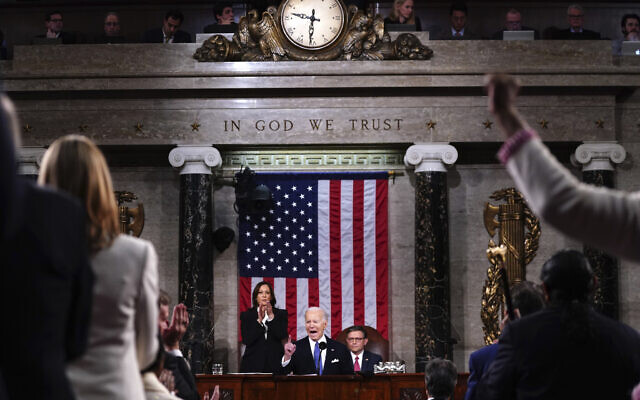 US President Joe Biden delivers the State of the Union address to a joint session of Congress at the Capitol, Thursday, March 7, 2024, in Washington. Standing at left is Vice President Kamala Harris and seated at right is House Speaker Mike Johnson, R-La. (Shawn Thew/Pool via AP)